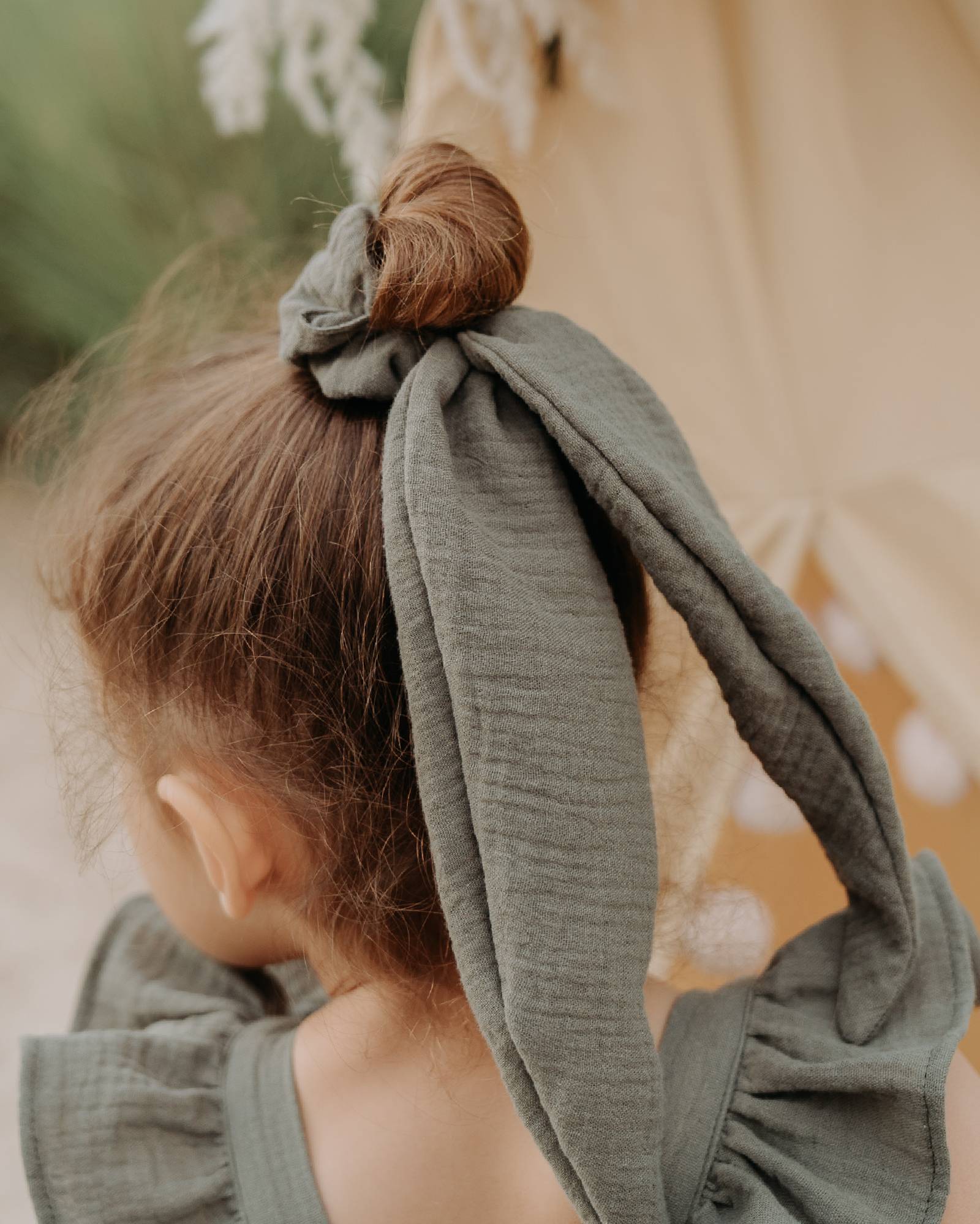 Girl model wearing the Scrunchie Long in Soft Khaki Green Muslin Cotton.