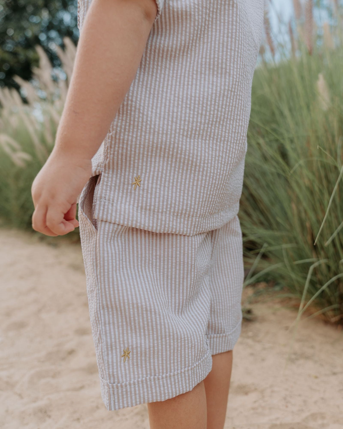 boy wearing the Charlie shirt in stripes beige white with matching Julian shorts by Les Vedettes