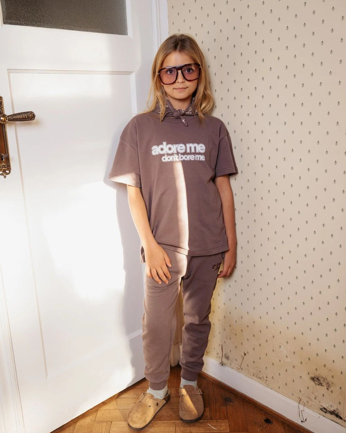 Girl wearing the unisex Adore Me Don't Bore Me t-shirt in organic cotton by Cos I Said So in peppercorn