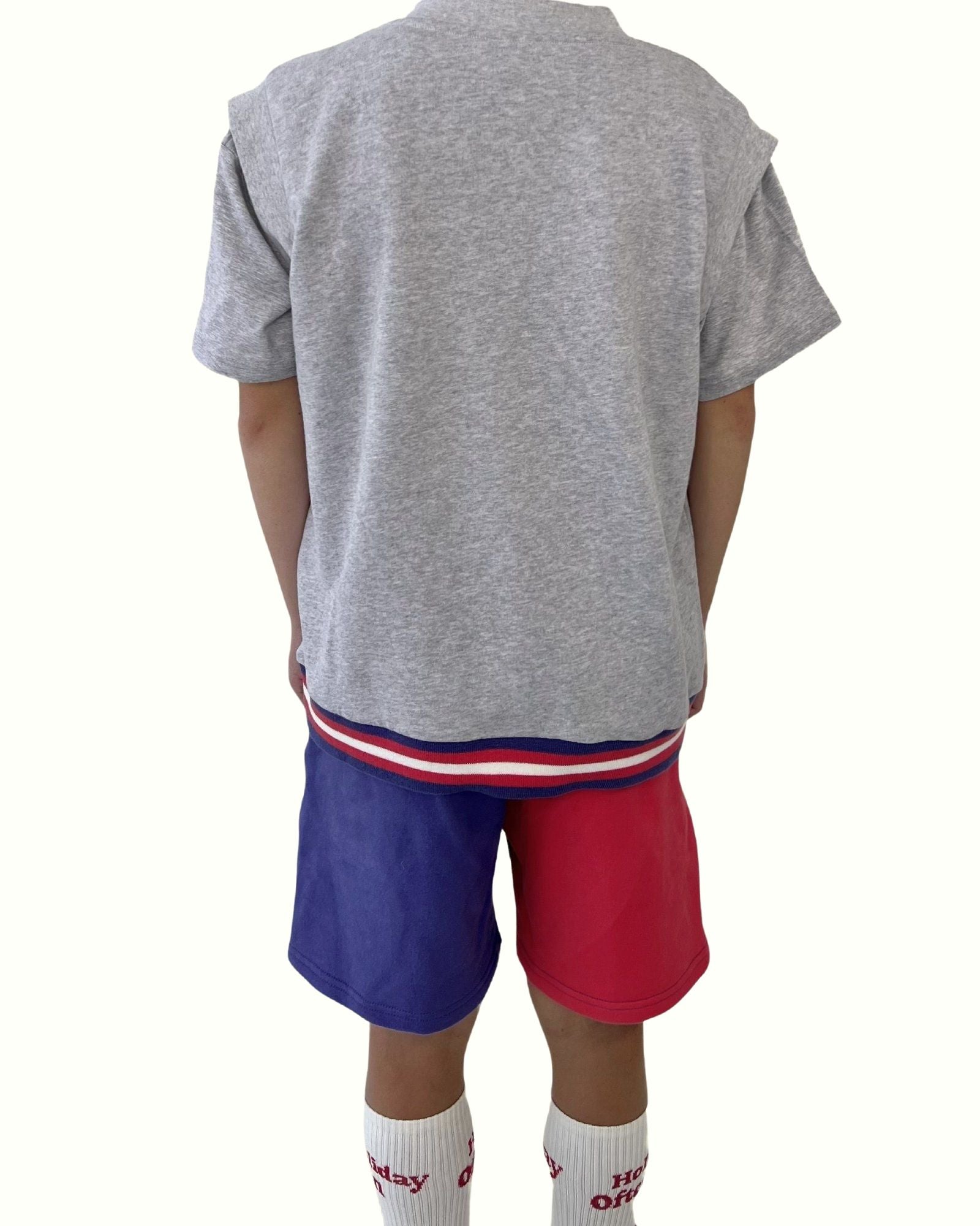 boy model wearing the color block jog shorts by Cos I Said So with the debardeur in grey high quality organic cotton showing the back