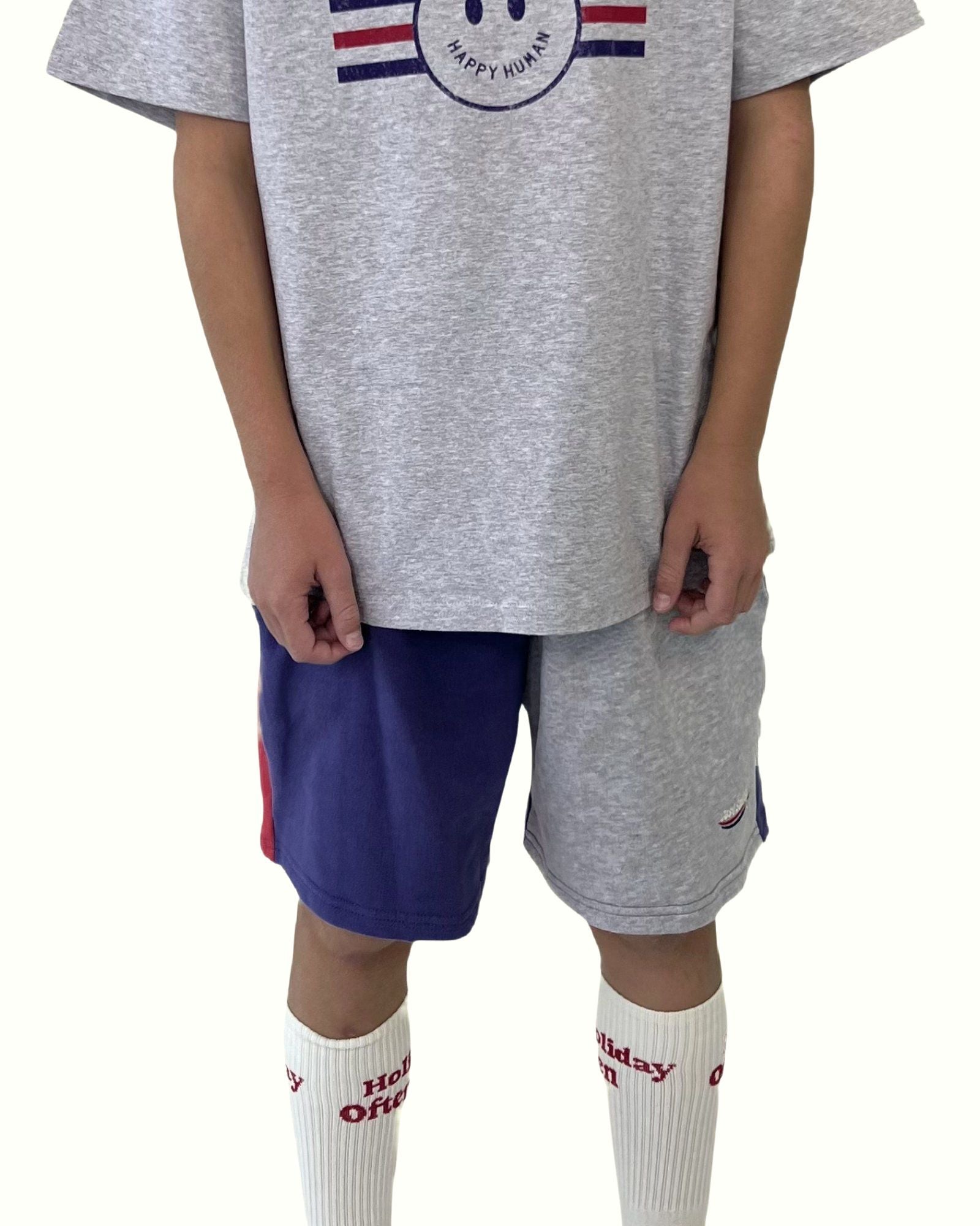 boy model wearing the comfy and stylish color block shorts by Cos I Said So with the smiley happy human t-shirt in grey high quality organic cotton