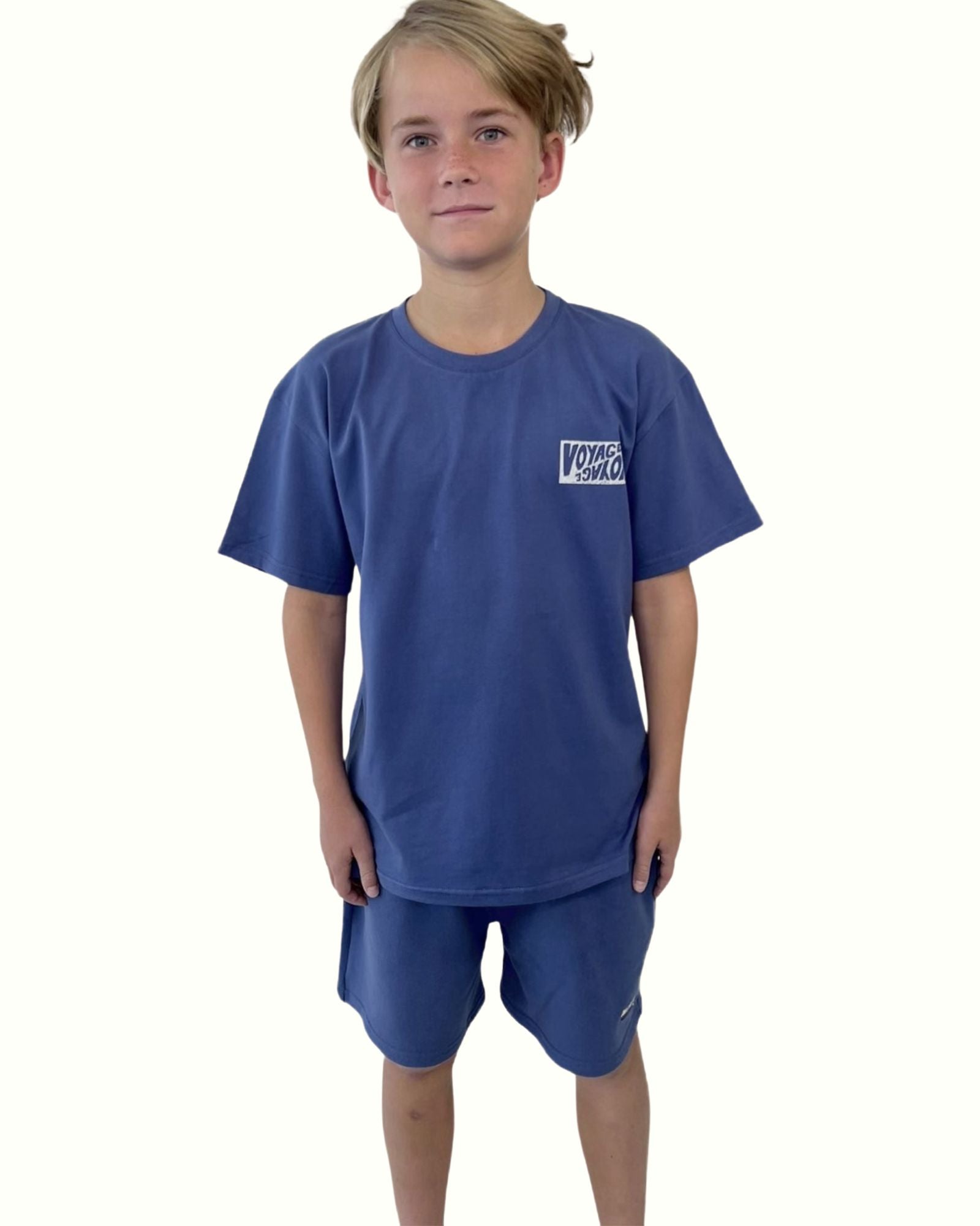 boy model wearing the t-shirt voyage by Cos I Said So in ultramarine blue with the jog shorts in ultramarine blue by Cos I Said So