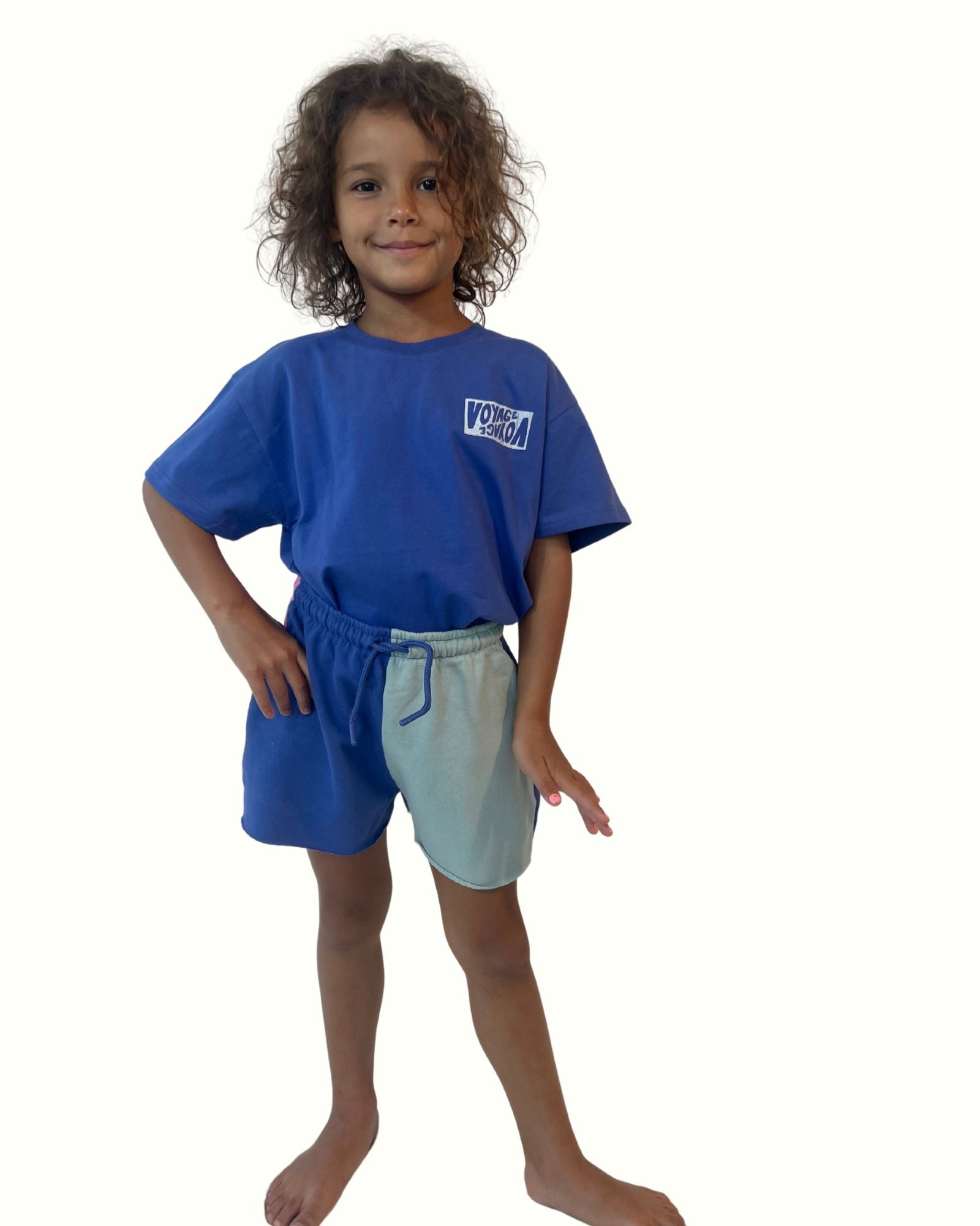 girl model wearing the color block shorts with matching unisex t-shirt voyage in ultramarine blue