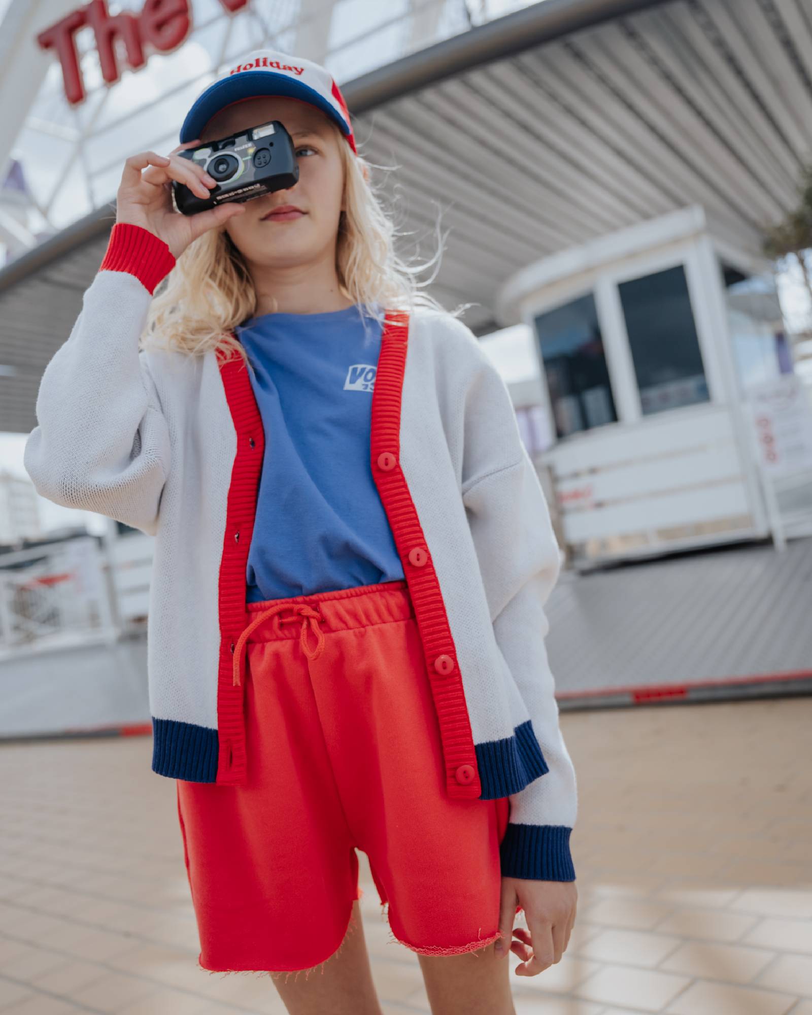 girl model wearing the cut off shorts in poinsettia red with the voyage voyage t-shirt in blue, both in the high quality fabric organic cotton