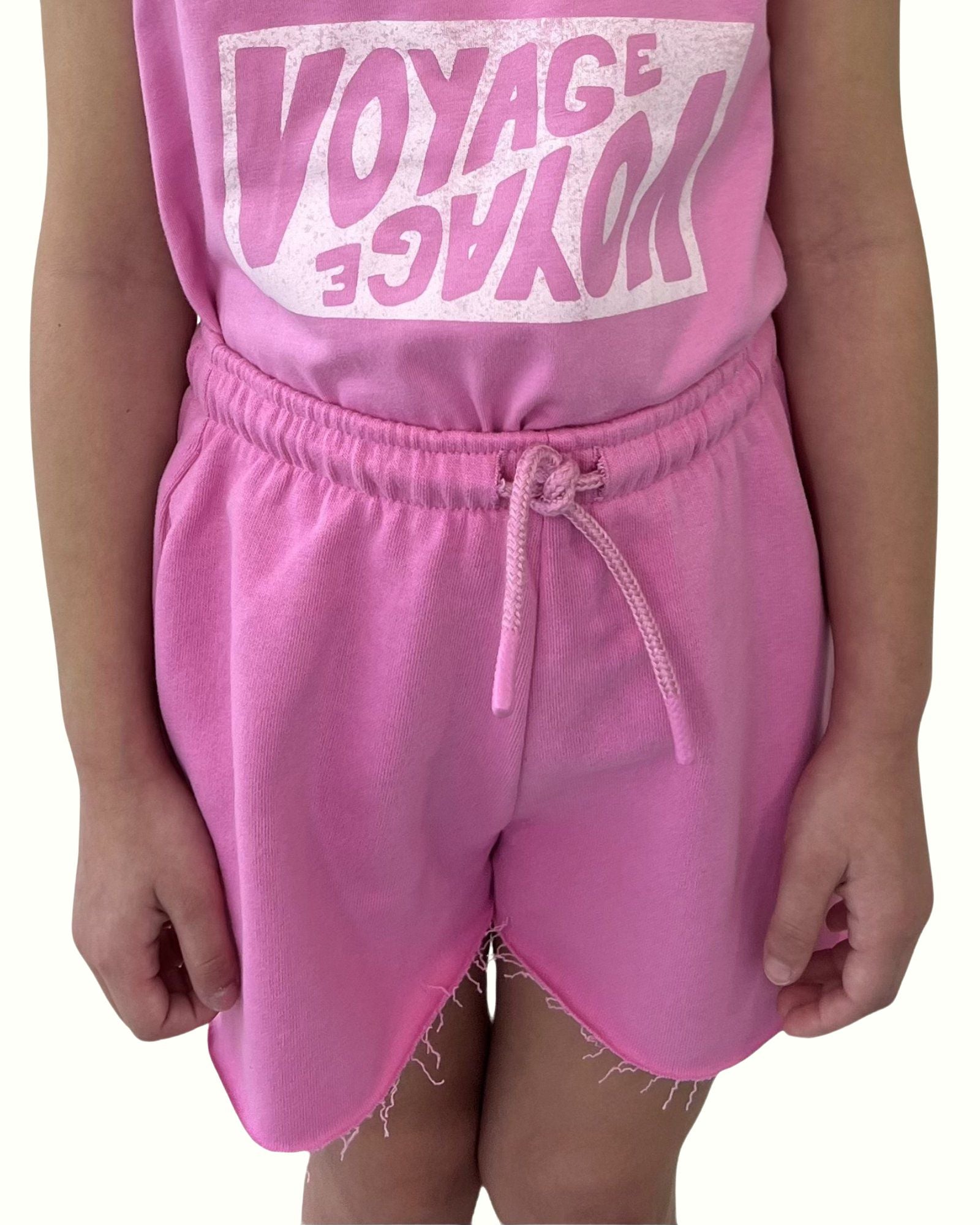 girl model wearing the comfy cut off shorts by Cos I Said So in the vibrant color fuchsia in high quality organic cotton