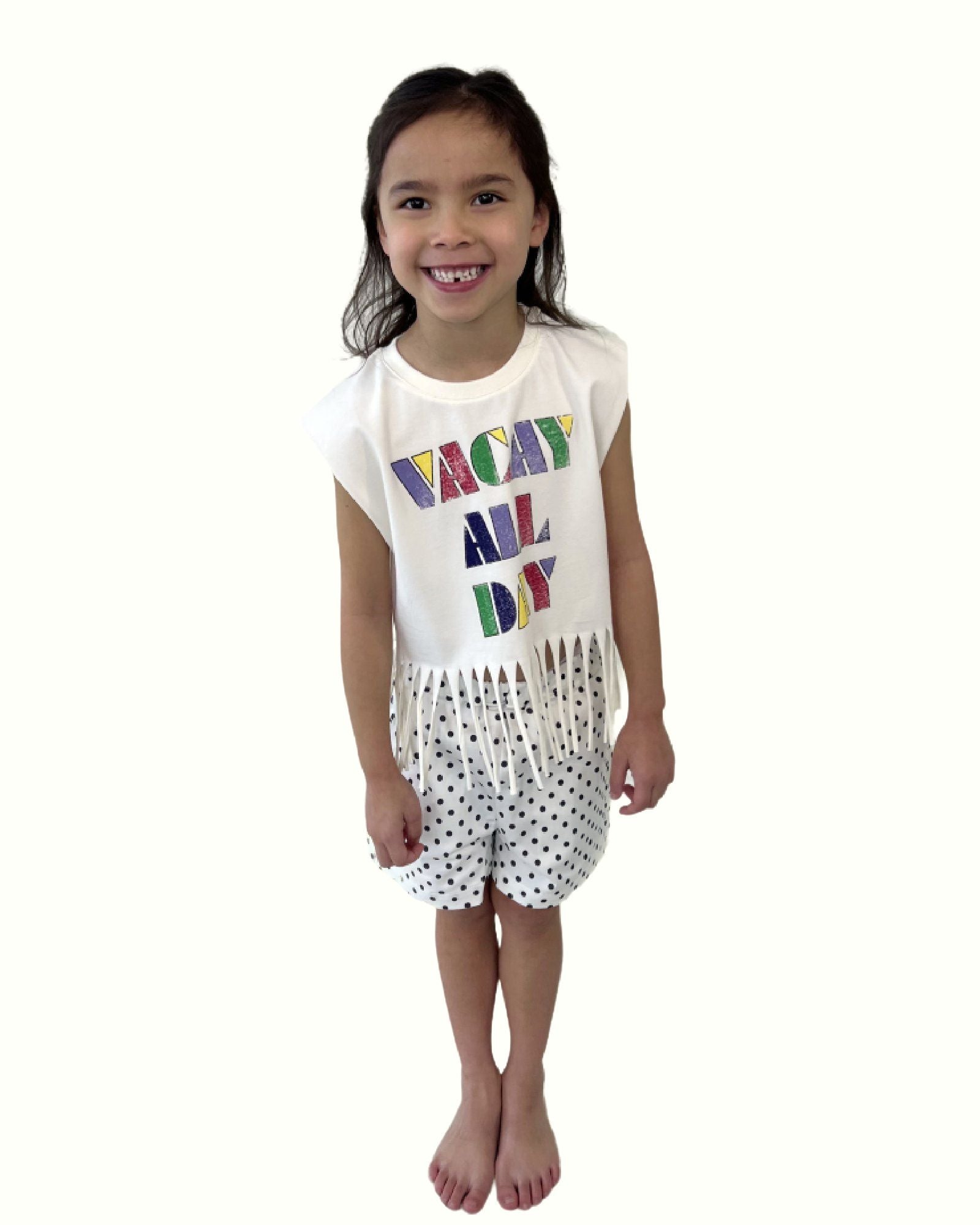 girl model wearing the polka dot shorts by Cos I Said So with the fringe top vacay all day
