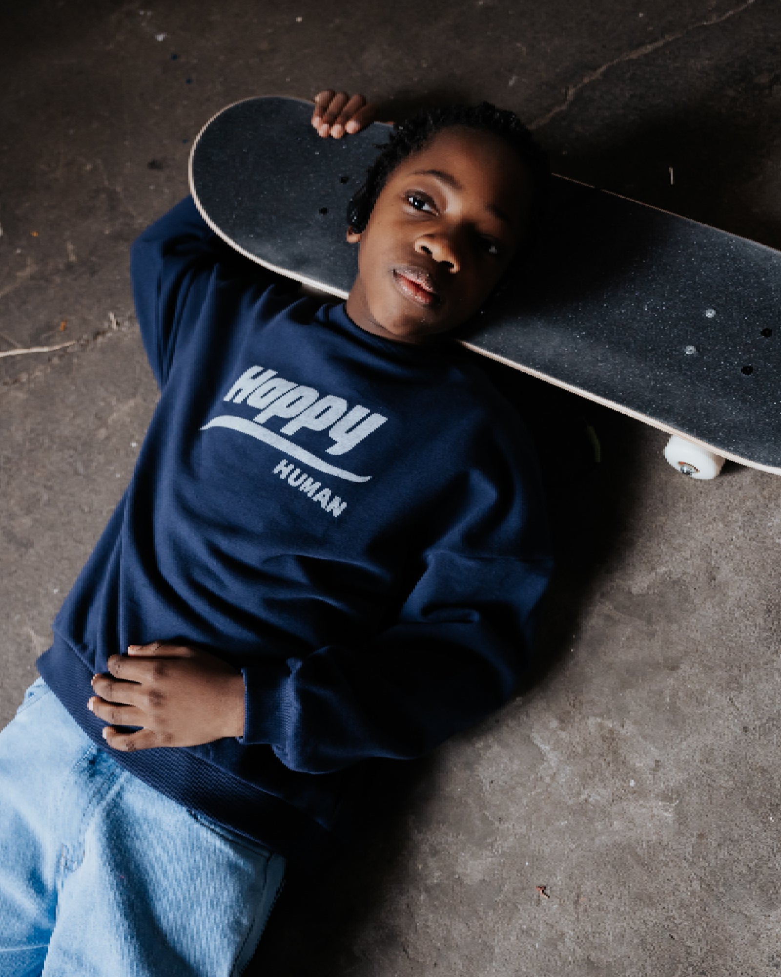 oy wearing the happy human sweater in maritime navy blue from Cos I Said So