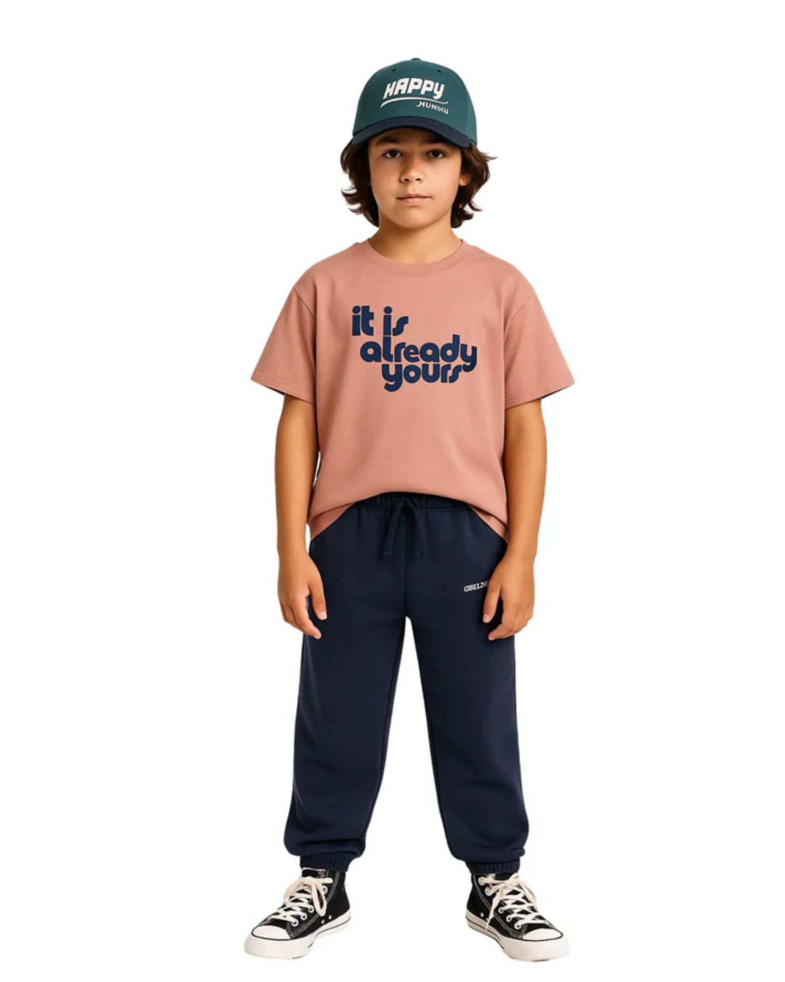 boy model wearing the it is already yours t-shirt in burlwood with the jog pants in maritime and the happy human cap