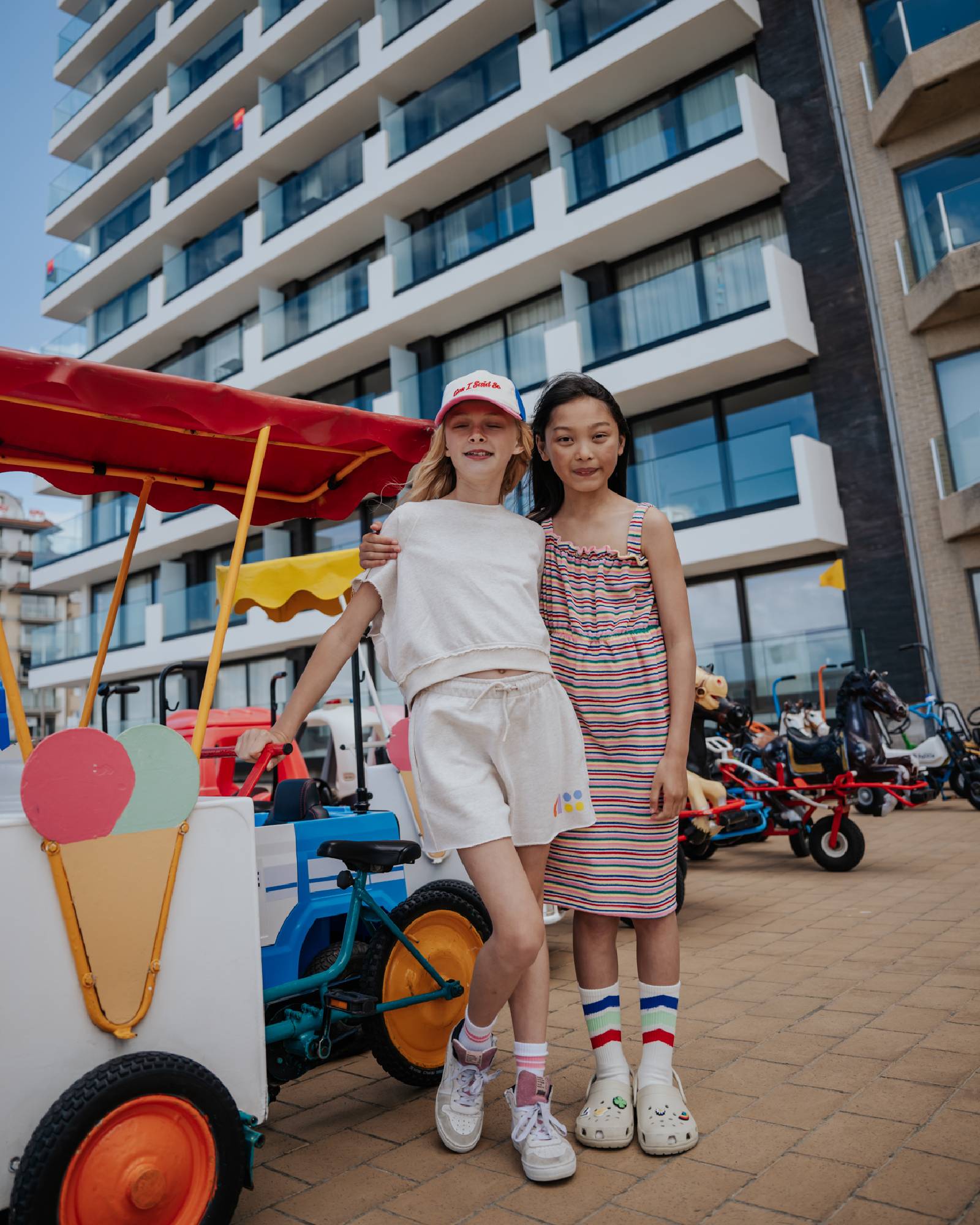 girl model wearing the jog top ciss in offwhite combined with the cut off jog shorts ciss in offwhite, combined with striped socks and the holiday often cap
