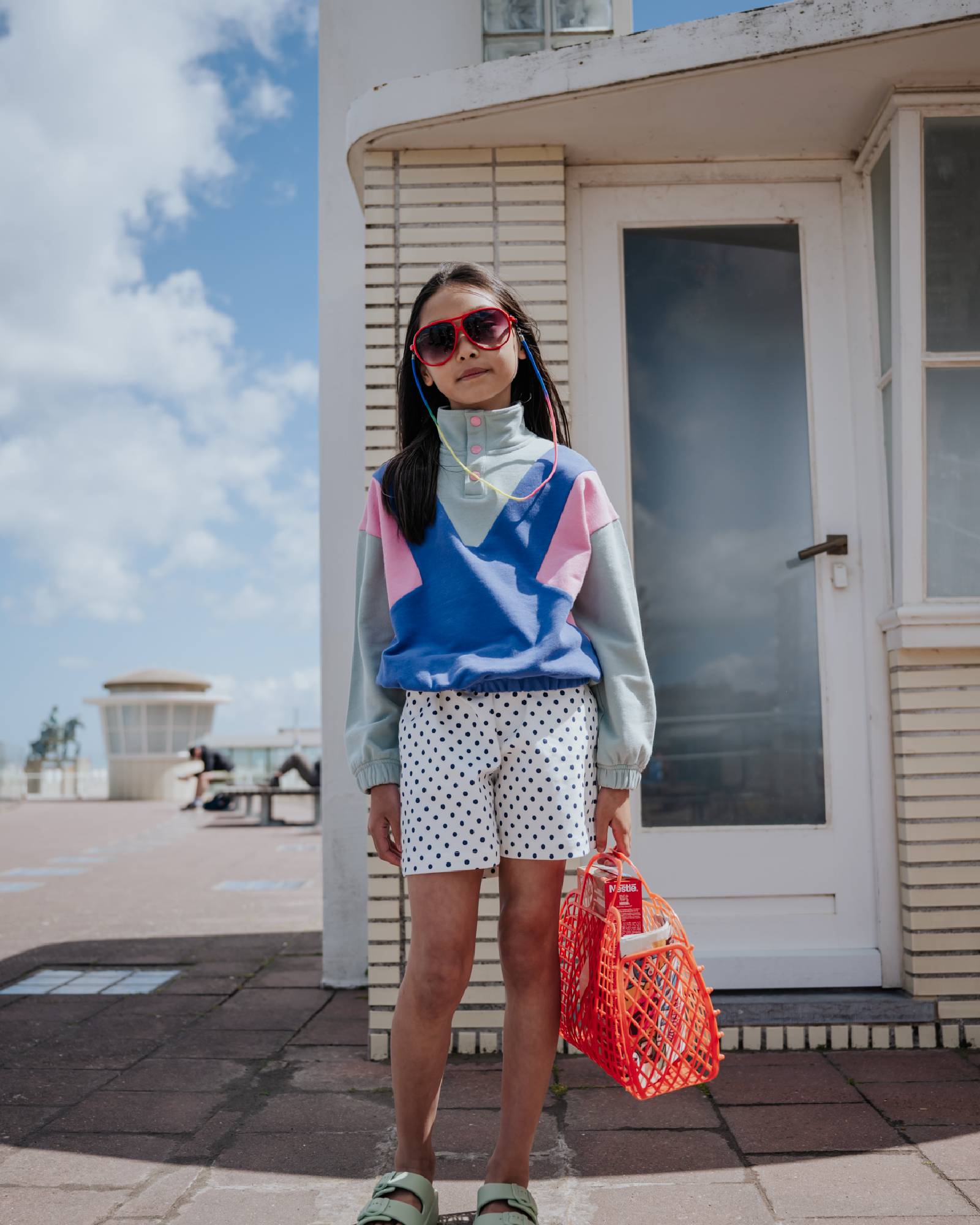 girl model wearing the polka dot shorts white with black dots