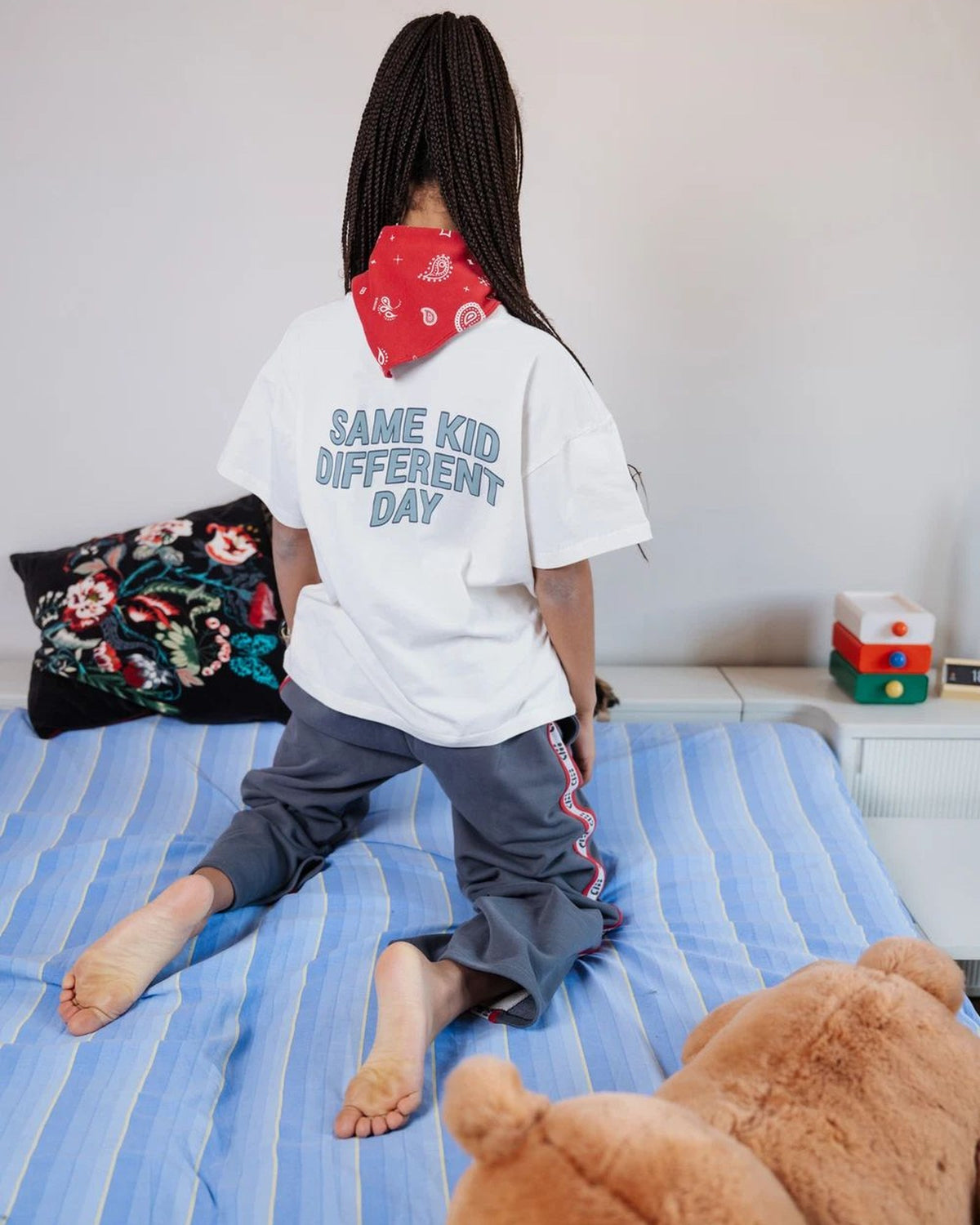 Girl wearing the white Same Kid Different Day kids T-shirt by Cos I Said So, back view