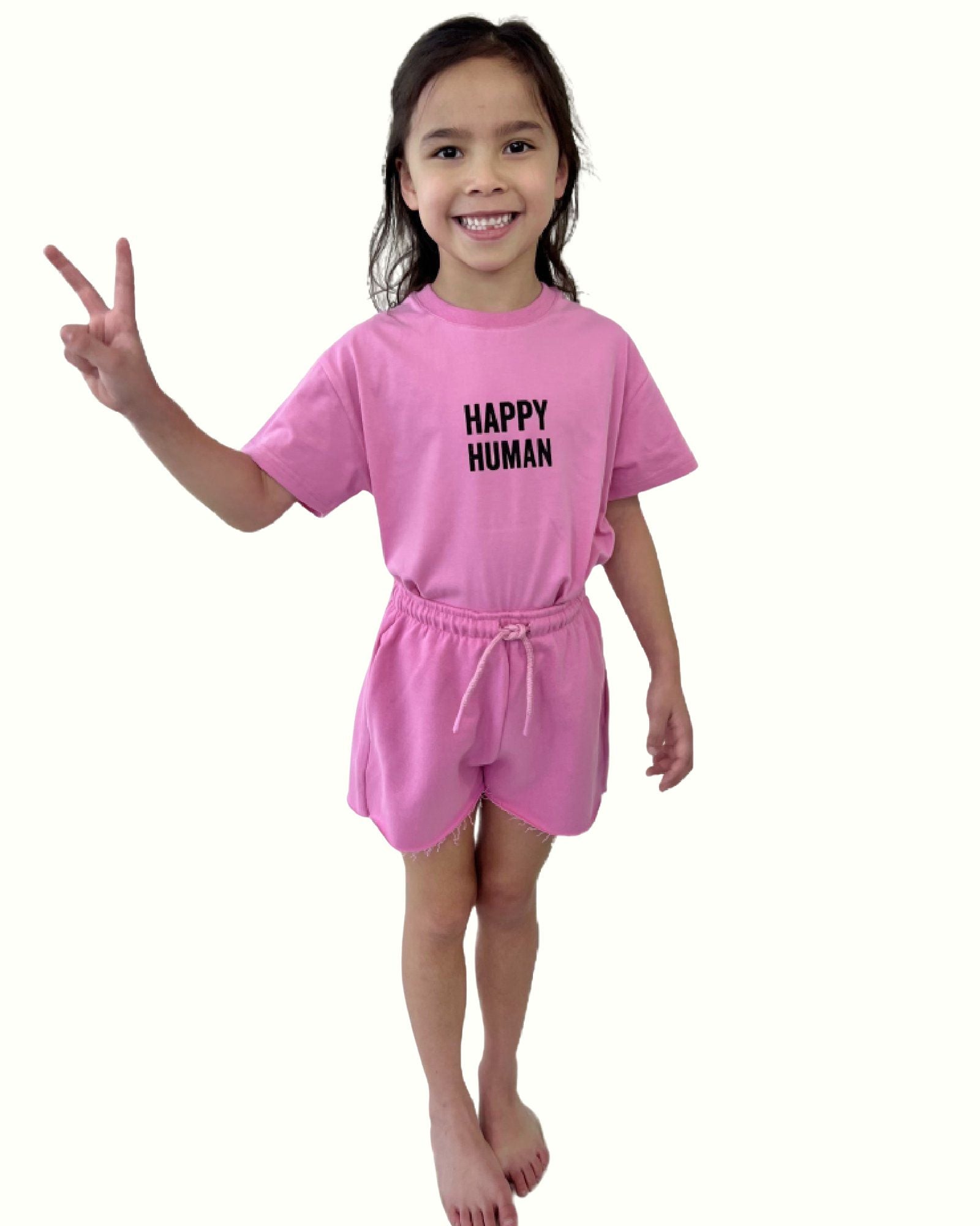 girl model wearing the happy human t-shirt in fuchsia with the matching cut off jog shorts in fuchsia by Cos I Said So