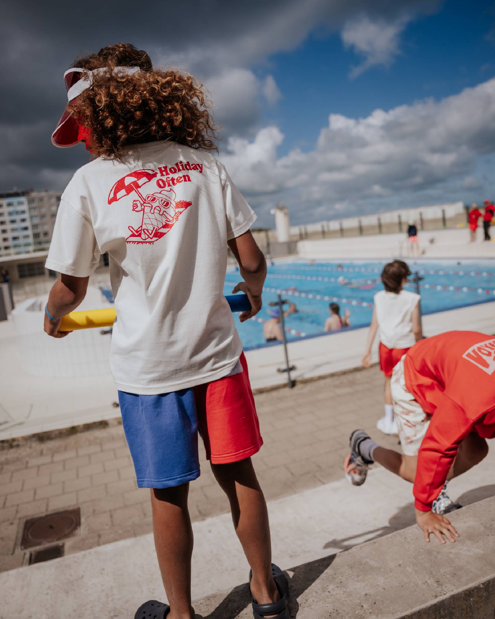 boy model showing the backside of the holiday often t-shirt and the color block jog shorts