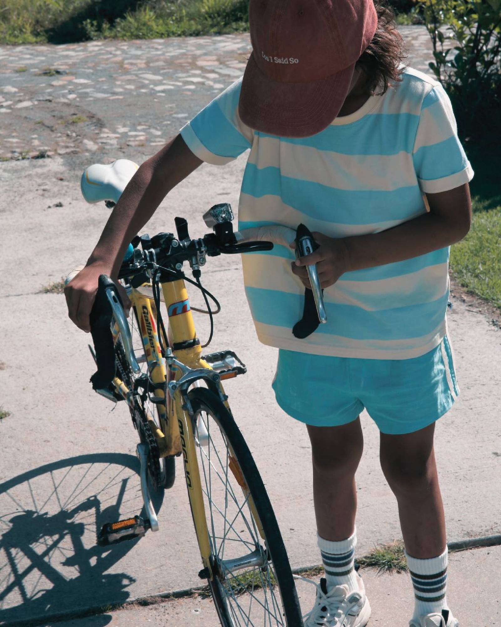 boy model wearing the linen shorts in turquoise with the striped t-shirt aqua haze anise