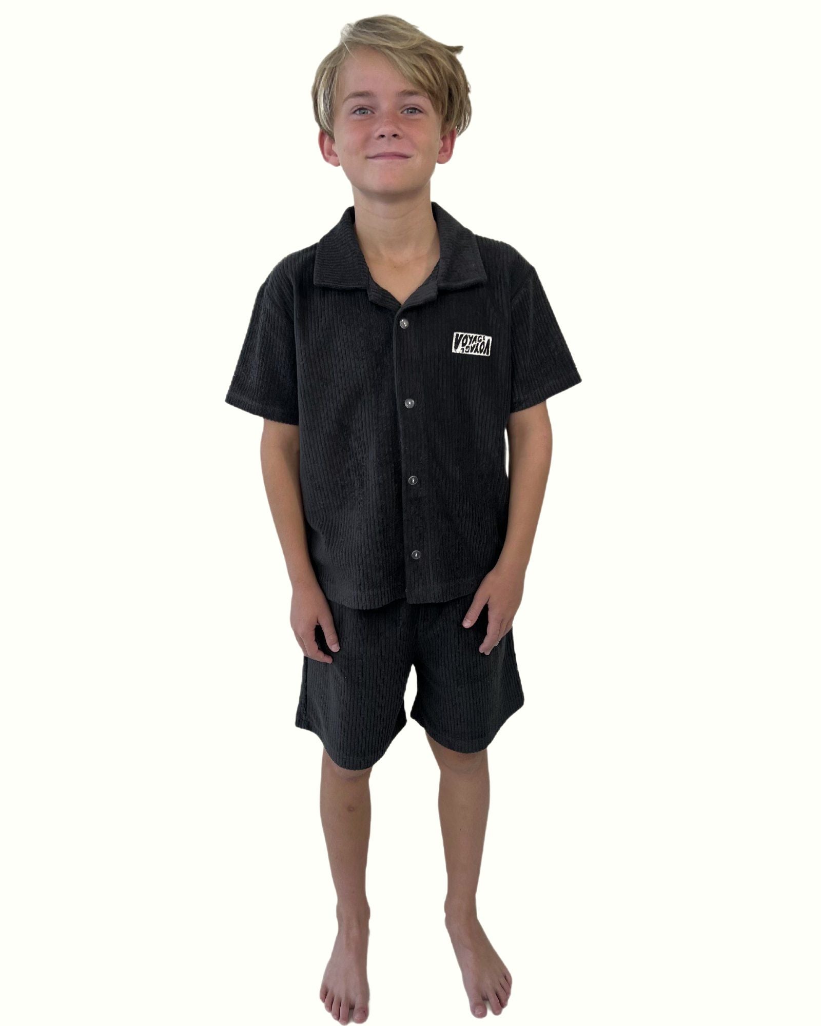 boy model wearing the towel terry shirt by Cos I Said So in charcoal with the matching towel terry shorts by Cos I Said So