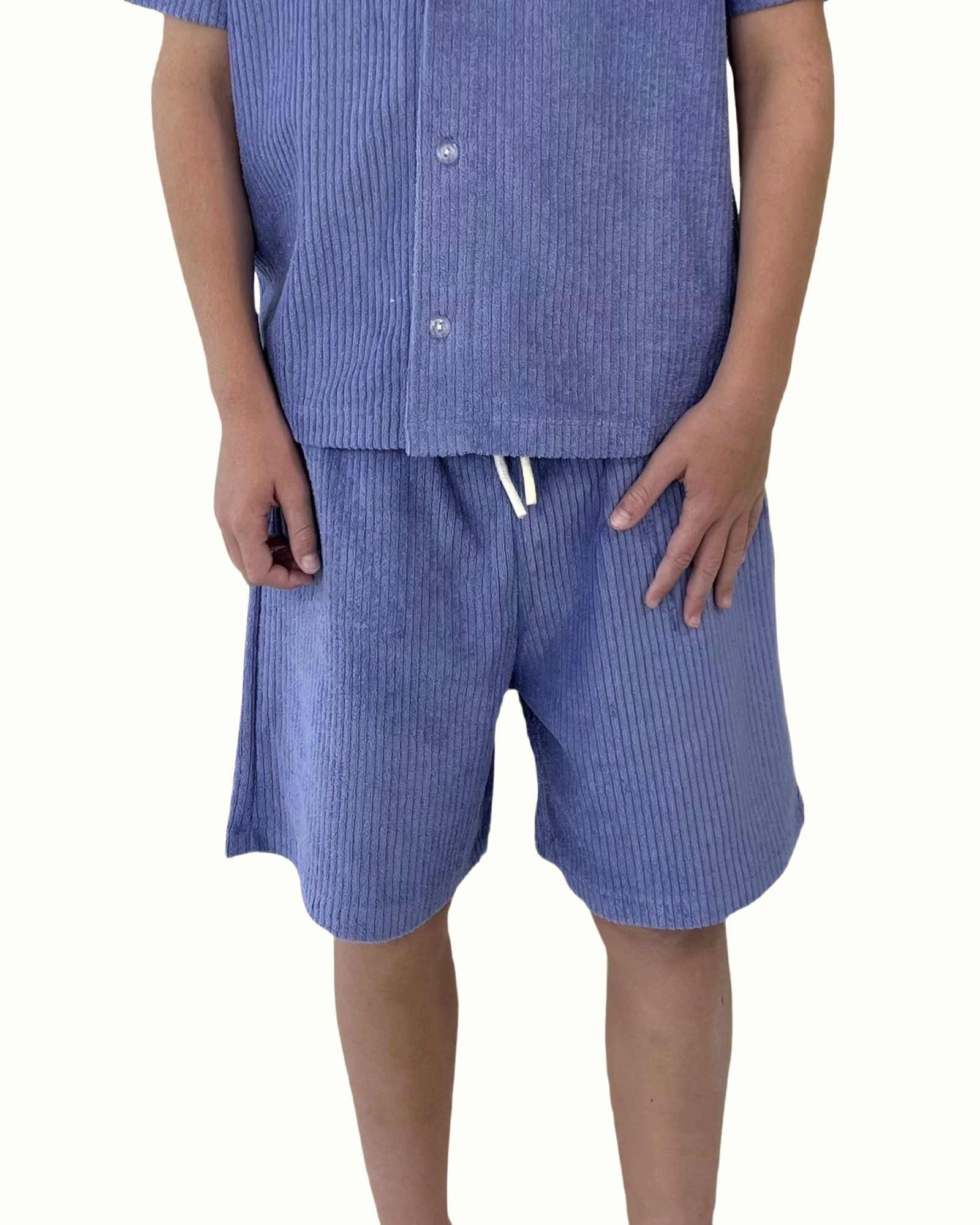 boy model wearing the comfy towel terry shorts in ribbed blue by Cos I Said So