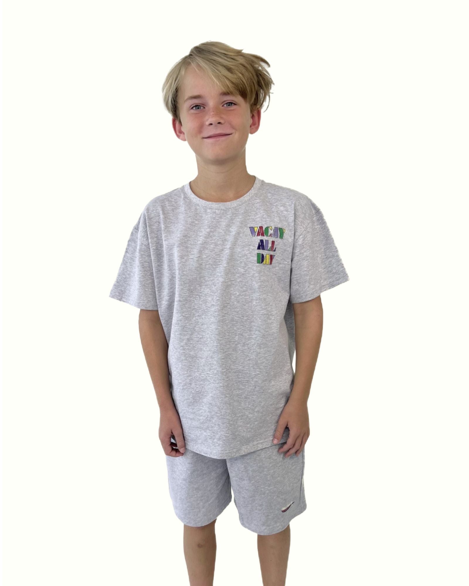 boy model wearing the vacay all day t-shirt in grey in soft organic cotton by Cos I Said So with matching grey jog shorts by Cos I Said So