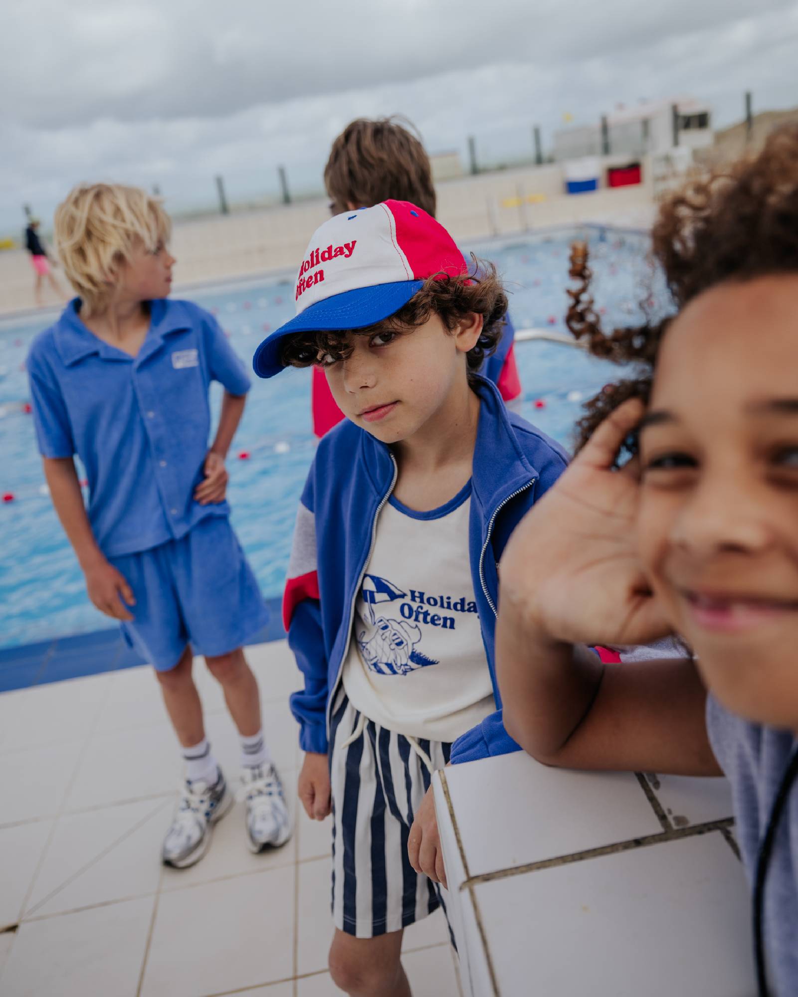 boy model wearing the holiday often tank top with the holiday often cap