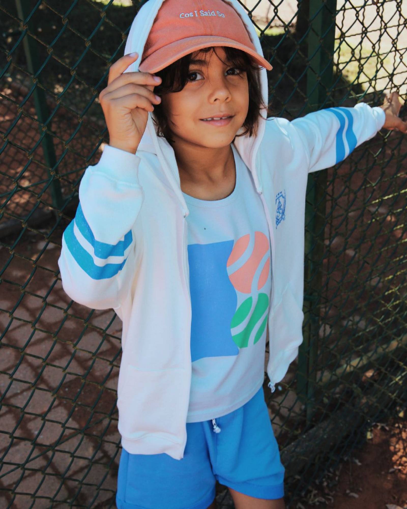 boy model wearing the outfit tennis tank top, combined with the zip hoodie and the jog shorts in granada sky