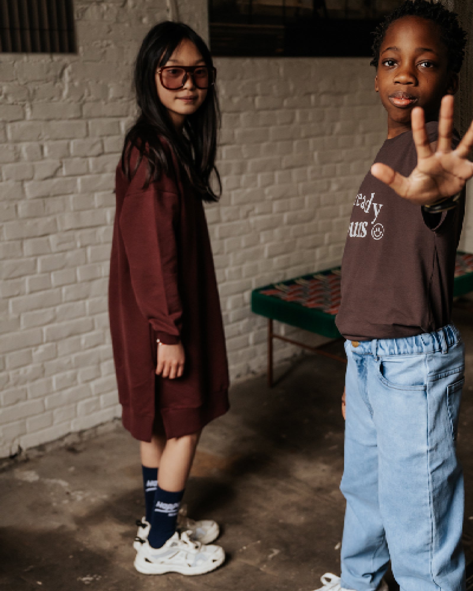 girl model wearing the v-neck sweater dress in port with the happy human socks