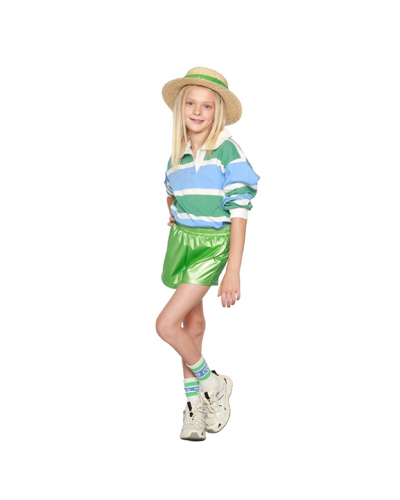 girl model wearing the vegan leather shorts in lime with ciss socks in white