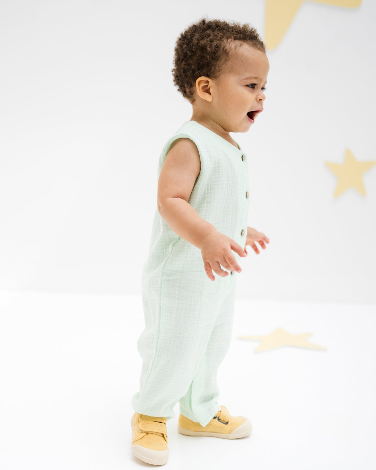 baby boy wearing the lois onesie in mint muslin cotton