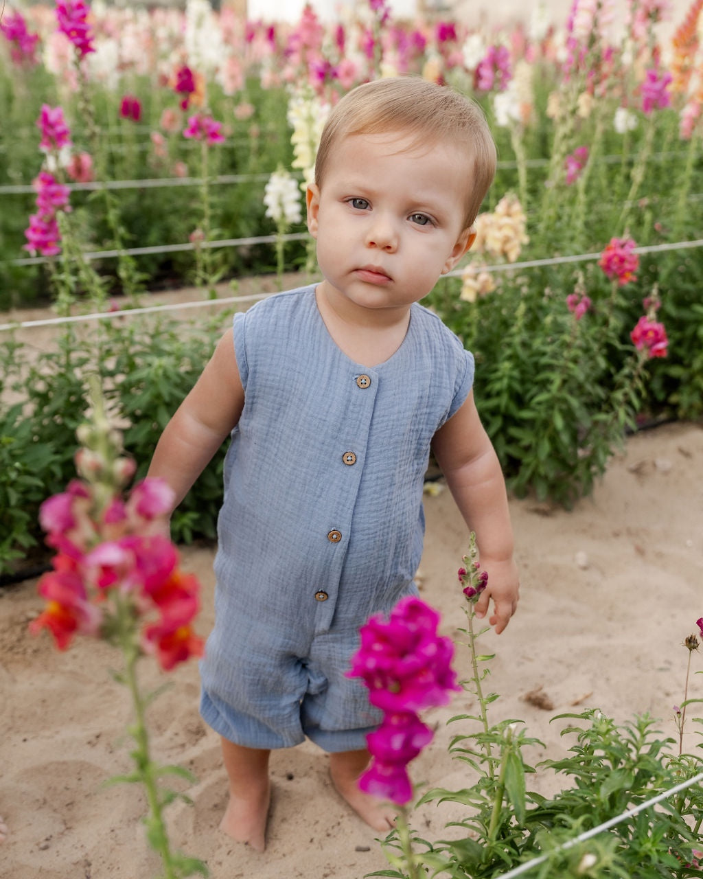 baby boy wearing the Lois onesie in cloudy blue muslin cotton
