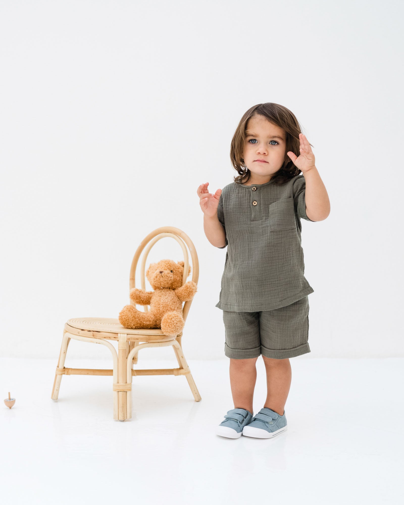 2-year-old bou wearing the Charlie shirt with the Julian shorts in khaki green