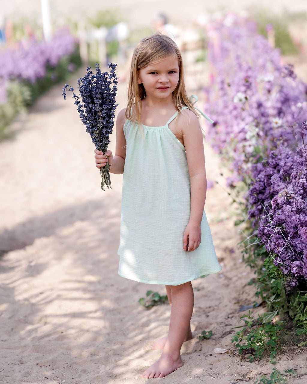 girl model wearing the Romy dress in mint green muslin cotton