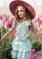 girl model wearing the Lilou shirt in mint with the Lila skirt in mint