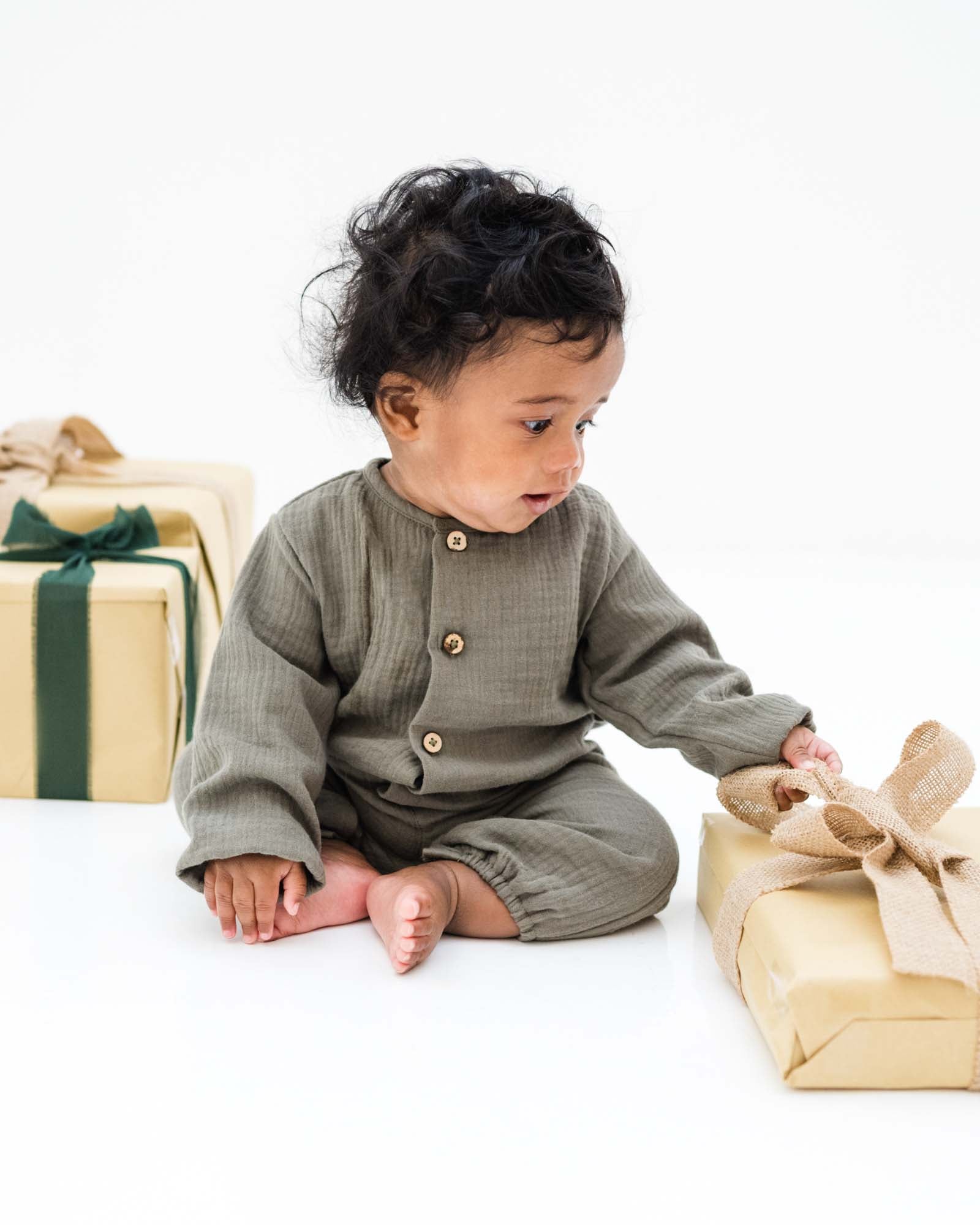 baby boy wearing the leo onesie in khaki size 0-6 months