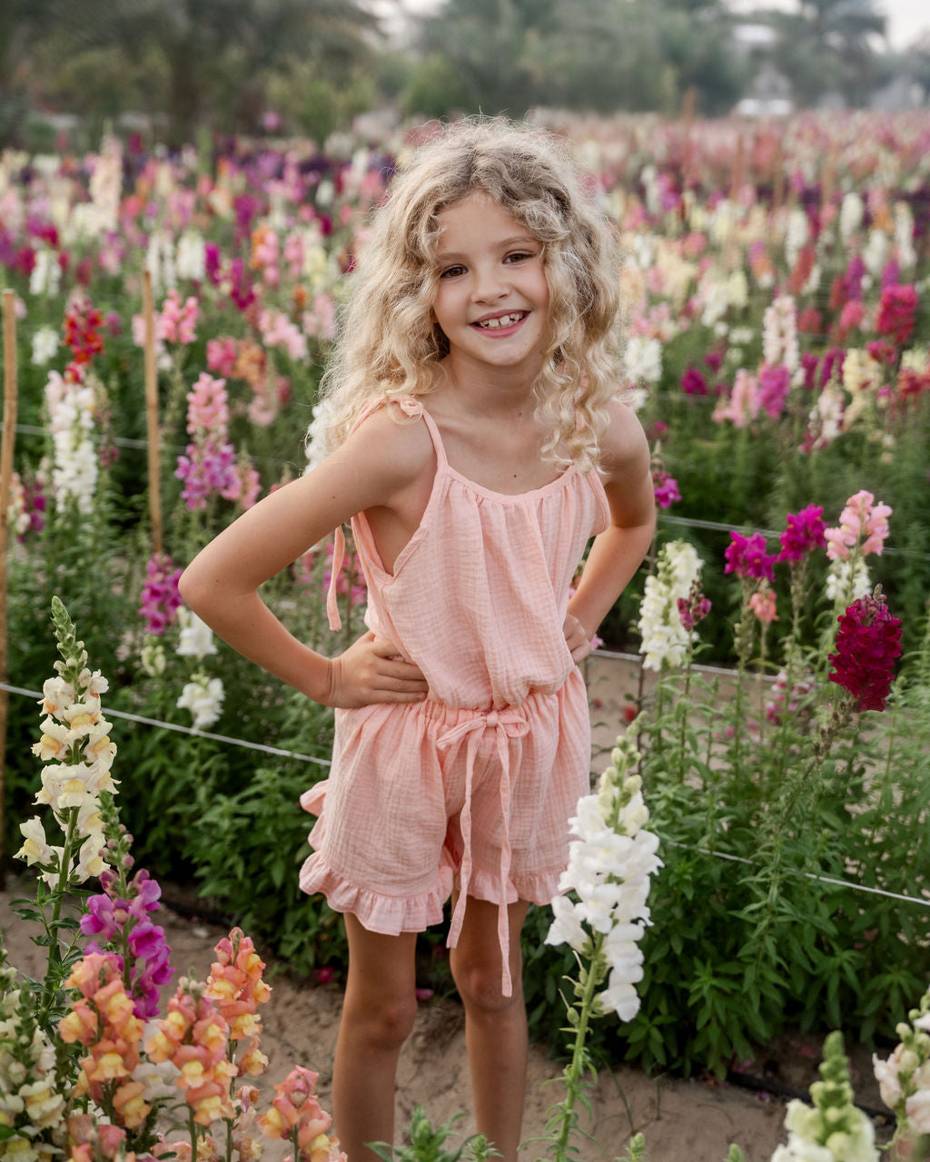 girl model wearing the Miu top and matching Charlene shorts in peach muslin cotton