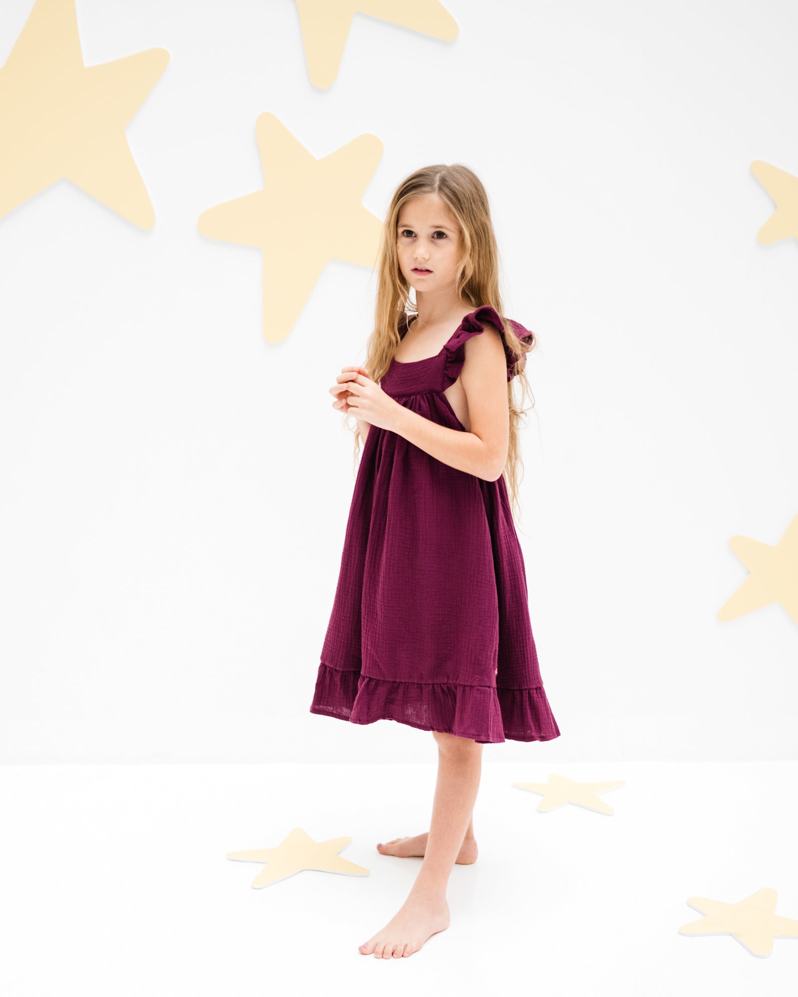 girl model wearing the river dress in aubergine muslin cotton