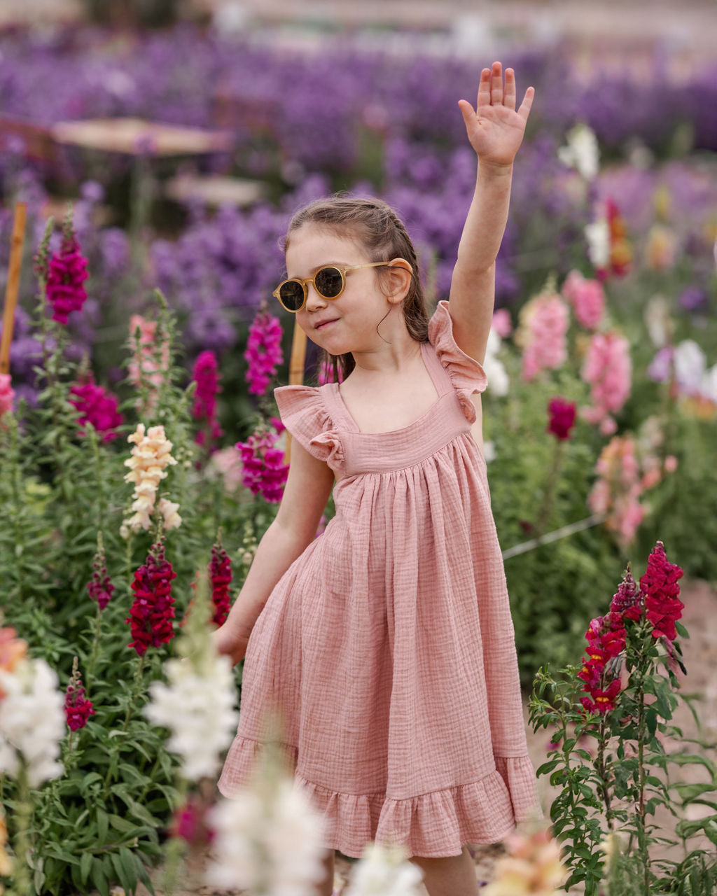 girl model wearing the River summer dress with frills in soft pink in high quality muslin cotton