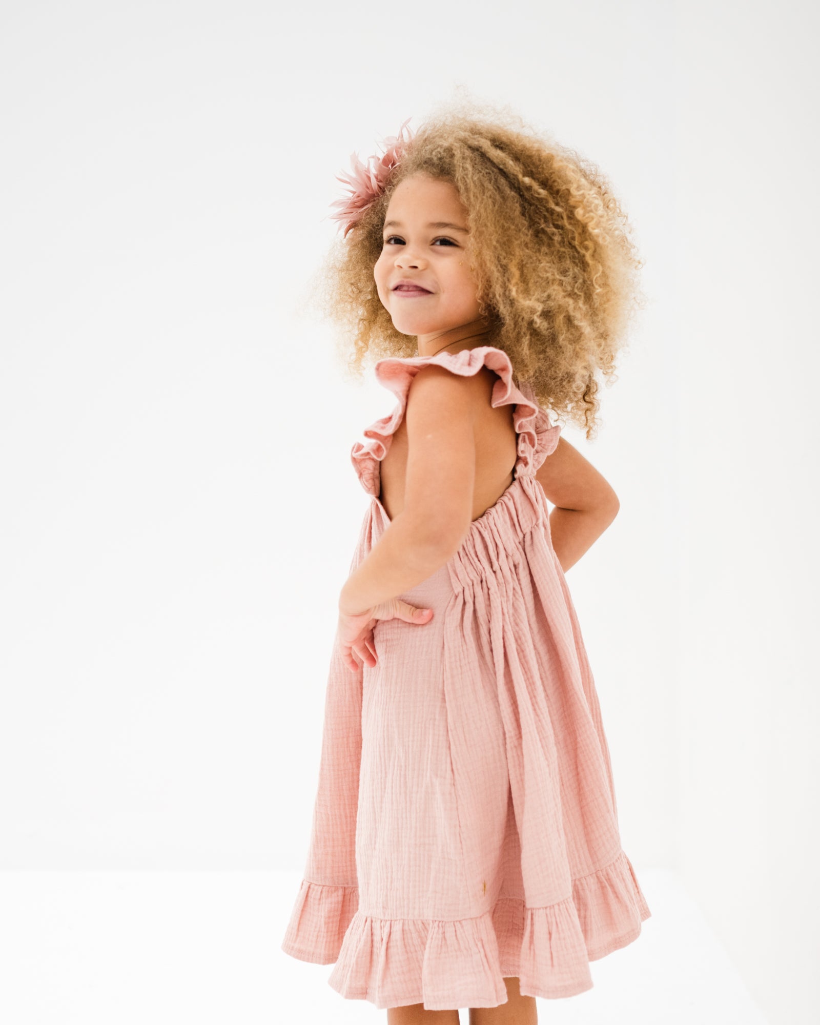 girl model showing the side of the river dress in soft pink muslin cotton