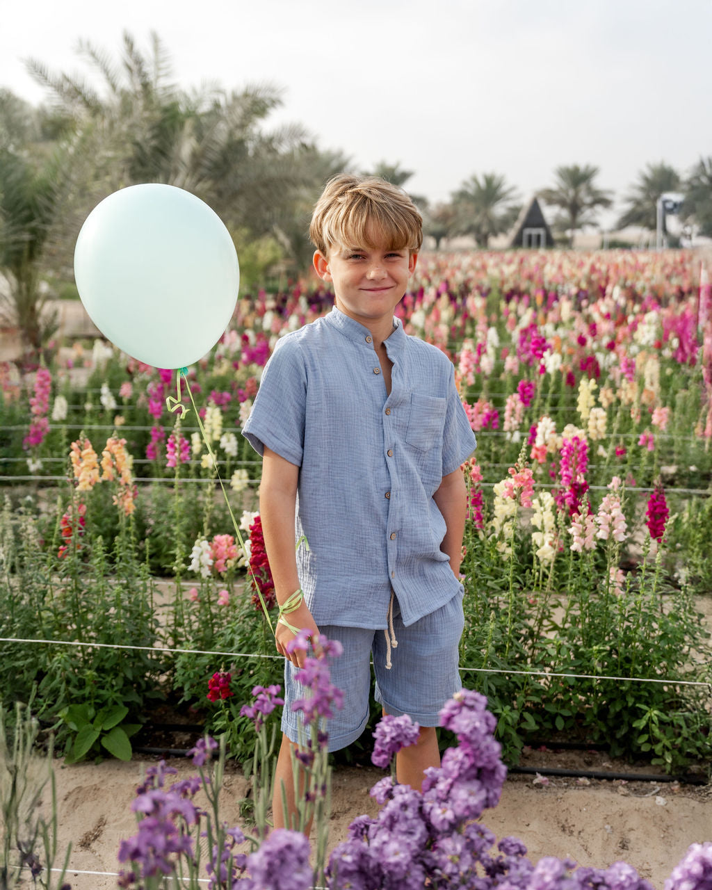 10-year-old boy wearing the raphael shirt with matching julian shorts in cloudy blue