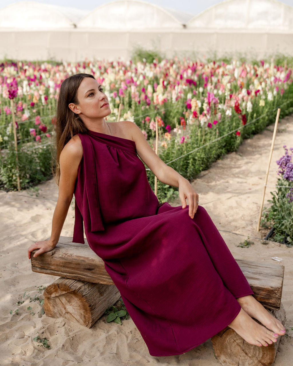 model wearing the assymetric Olympia dress in aubergine muslin cotton