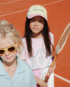 Girl model wearing the Country Club T-Shirt in Lilac Snow, combined with the Color Block Cut Off Jog Shorts.