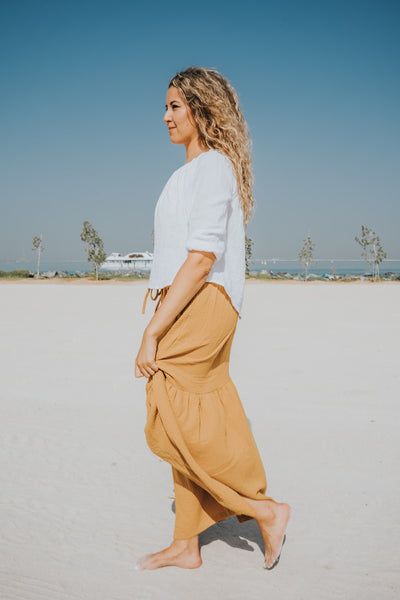 This maxi skirt from Les Vedettes is a long skirt that comes in a mustard colour. The skirt has an elastic and straps in the waist to easily adjust.