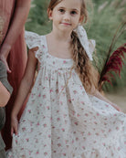 Girl model wearing the RIver Dress in Wildflower Muslin Cotton, combined with the matching Scrunchie Long.