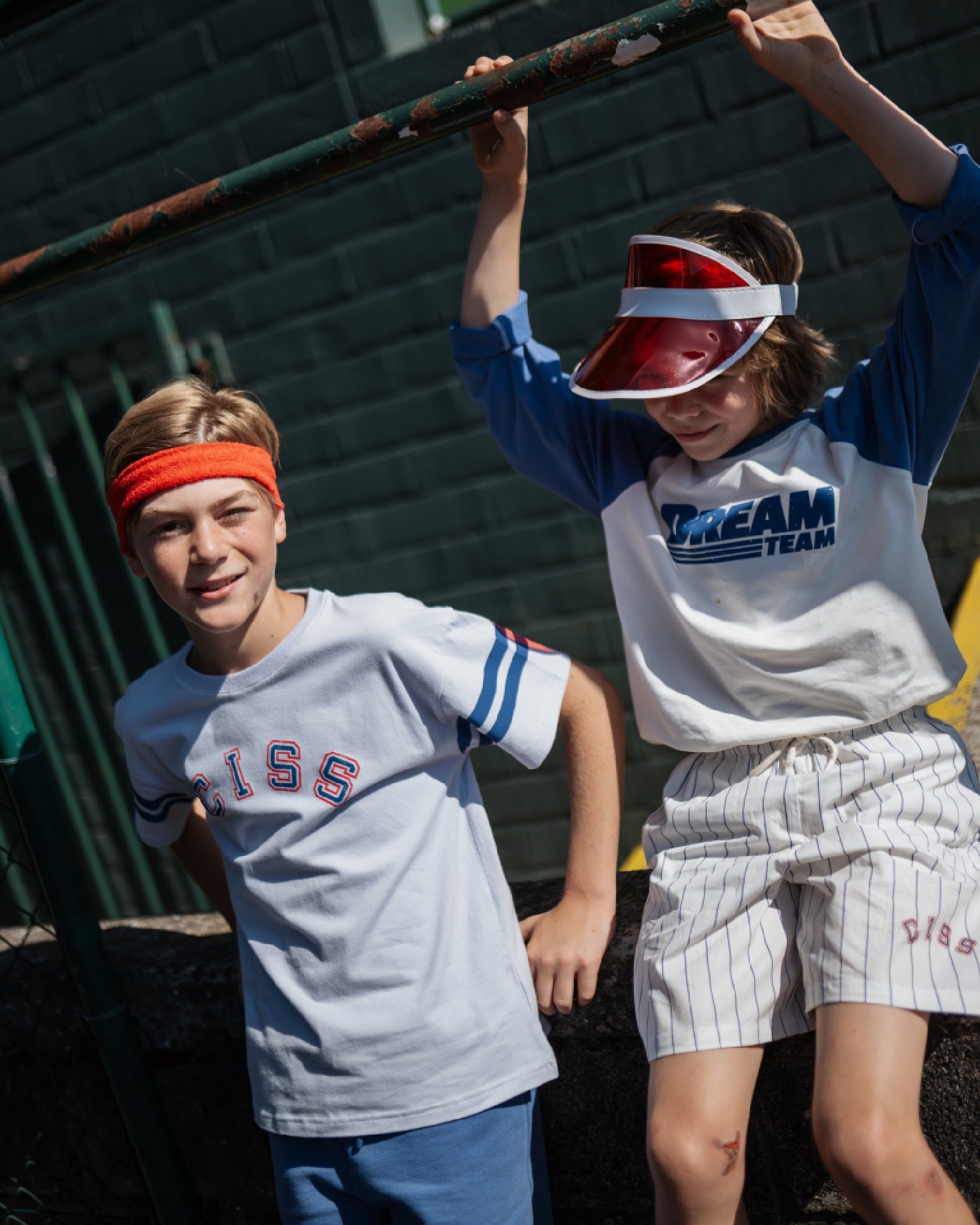 boy model wearing ciss t-shirt and pin striped shorts