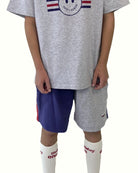 boy model wearing the comfy and stylish color block shorts by Cos I Said So with the smiley happy human t-shirt in grey high quality organic cotton 
