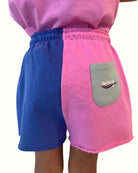 girl model showing the cut off shorts in color block by Cos I Said So from the back