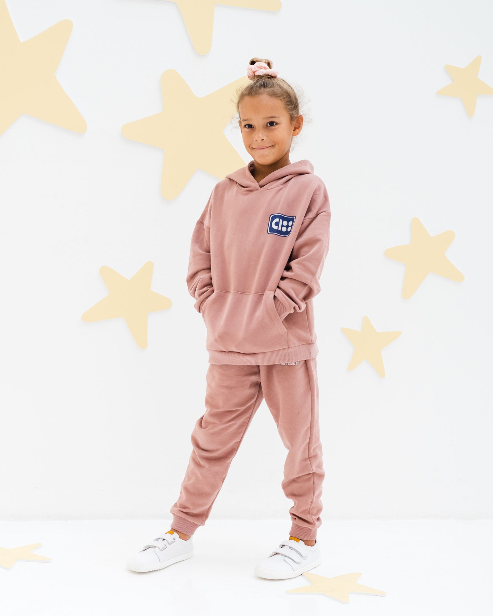 7-year-old girl model wearing the wonderyears hoodie in burlwood  with matching jog pants in soft organic cotton from Cos I Said So