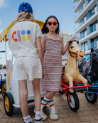 girl model wearing the jog top ciss, showing the multi colored logo on the back