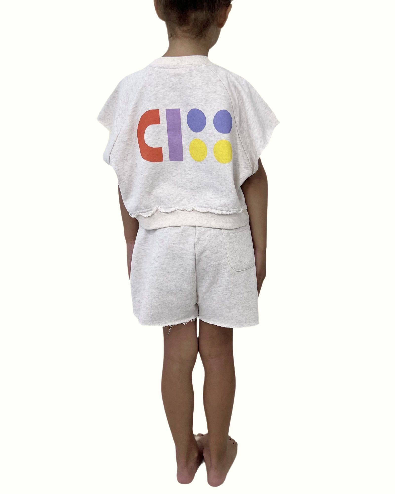 girl model showing the backside of the ciss jog top and cut off jog shorts in off white by Cos I Said So in the best quality organic cotton