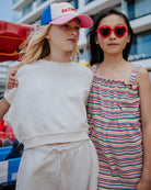 girl model wearing the jog top ciss in off white combined with the cut off jog shorts ciss in off white