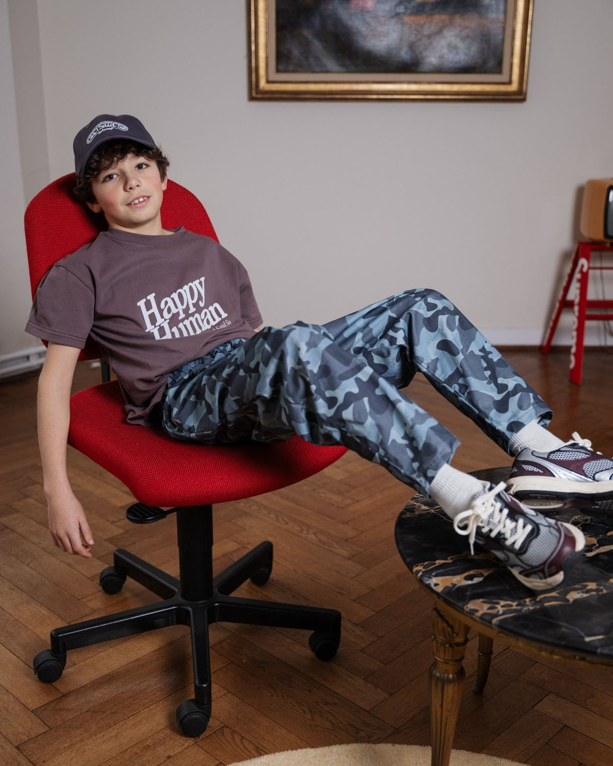 Teenage boy wearing the Happy Human t-shirt in organic cotton in peppercorn plum, by Cos I Said So
