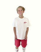 boy model showing the holiday often t-shirt with the jog shorts in poinsettia red and the holiday often socks by Cos I Said So