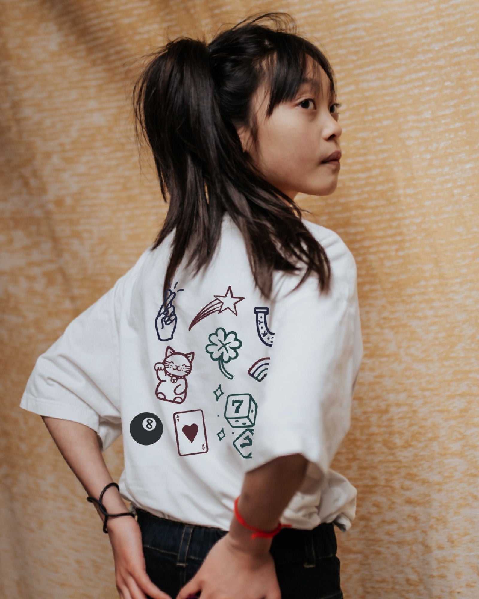 girl model wearing the lucky charms t-shirt in powder from the back 